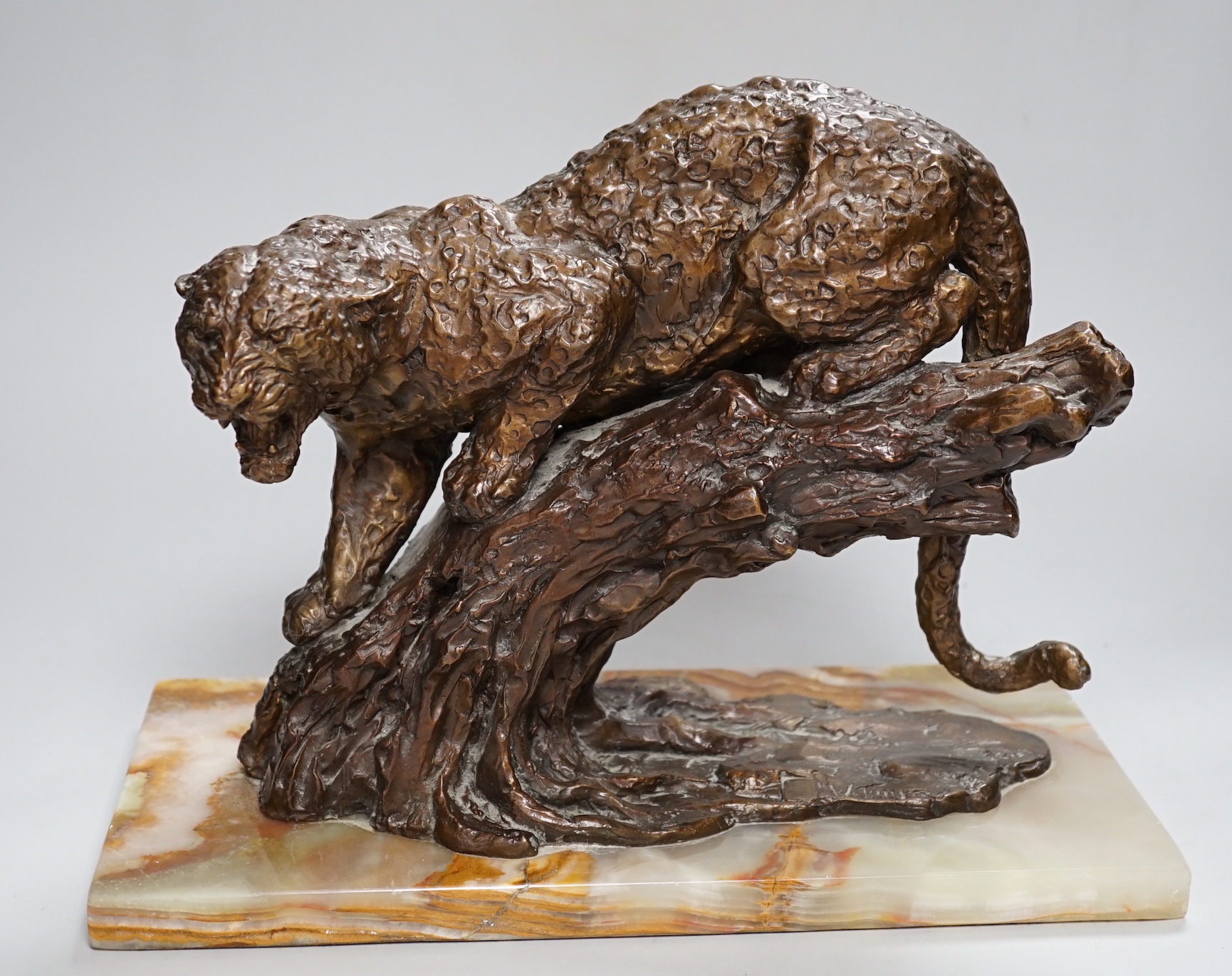 William Timym (British, 1902-1990). A bronze model of a jaguar crouched upon a tree trunk, signed in the bronze with Morris Singer foundry stamp, on green onyx plinth, 34.5cm long, deep 16cm, 25cm high